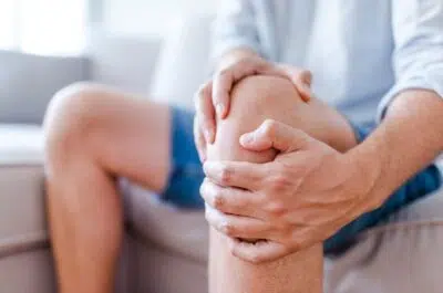 Personne âgée se tenant le genou – éviter la chirurgie en cas d'arthrose | IK Kiné et Balnéo
