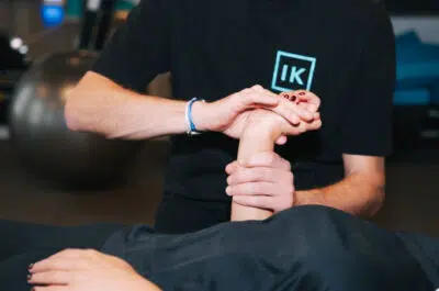 Kiné examinant le poignet d'un patient – douleurs du poignet, traitements | IK Kiné et Balnéo